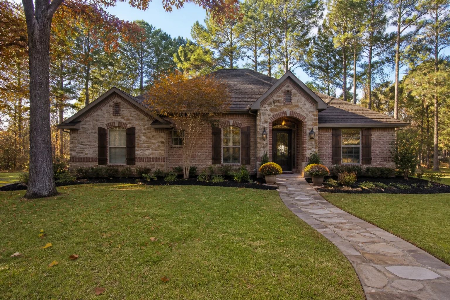 Fall curb appeal with fresh mulch and mums at an East Texas home